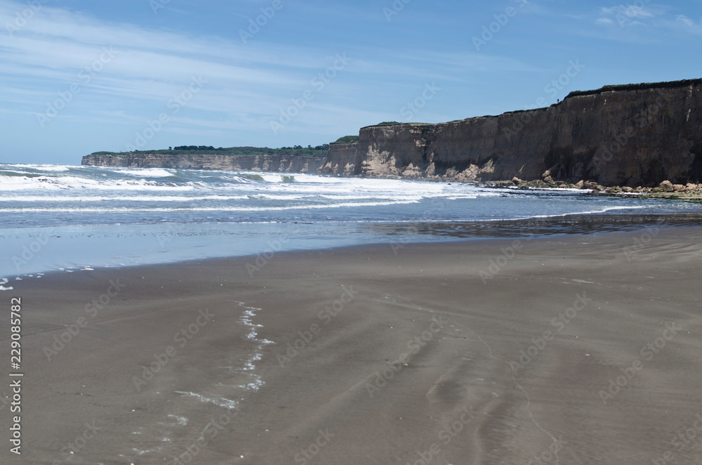 beach landscape with cliffs in the background