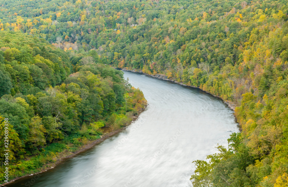 Autumn scene of Delaware River viewed from New York State Route 97, located at Hawks Nest. The mountain rises hundreds of feet above the Delaware river