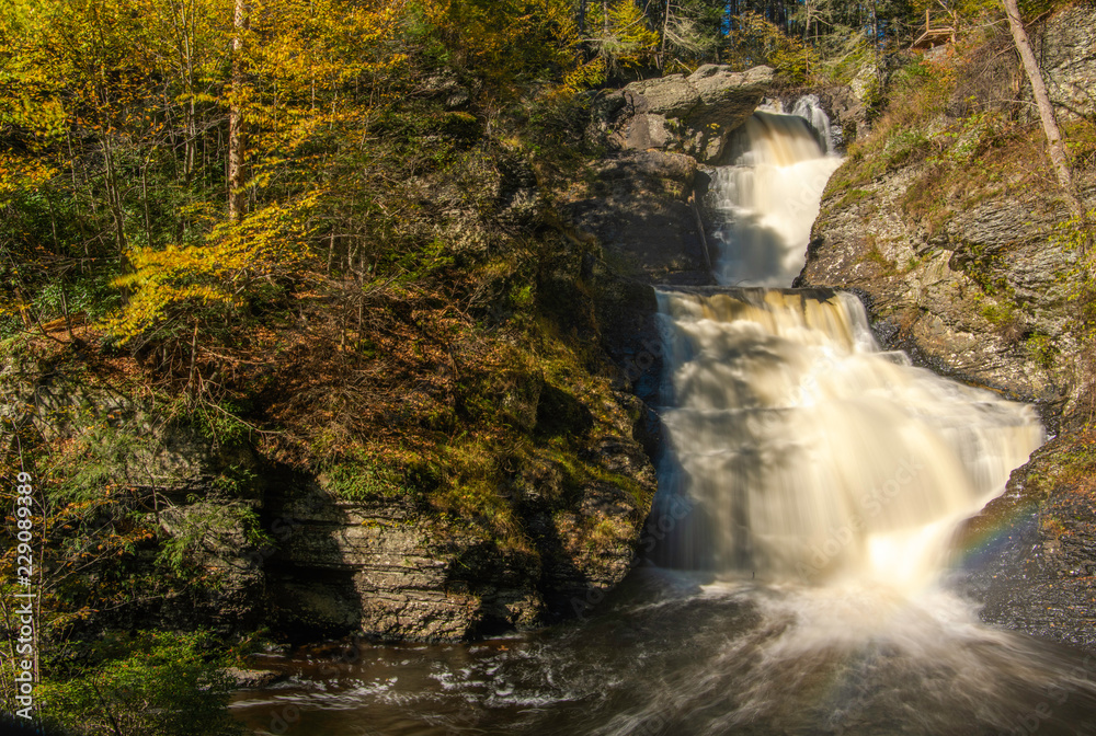 Beautiful autumn waterfall at Delaware Water Gap National Recreation Area in Pennsylvania with fading rainbow Beautiful autumn waterfall at Delaware Water Gap National Recreation Area in Pennsylvania with fading rainbow