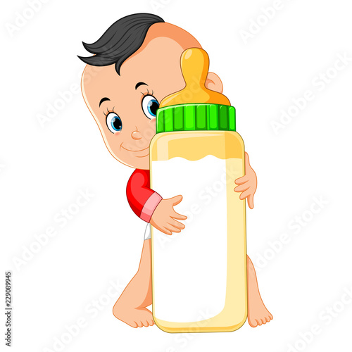 the baby happy playing and hug the milk bottle