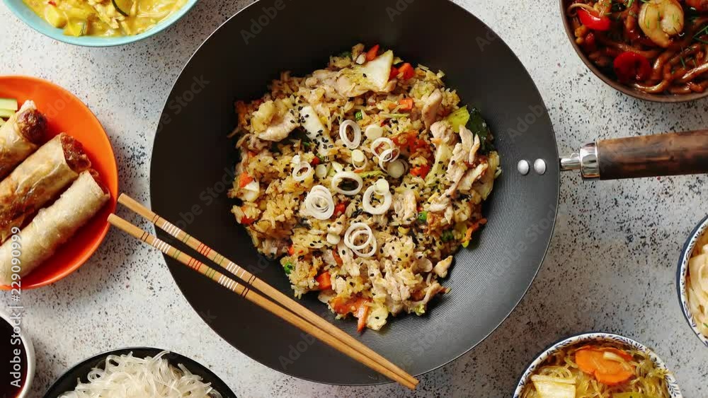 Chinese food set. Chinese noodles, fried rice with chicken, tom yum soup, spring rolls, deep fried fish and udon. Top view. Asian style food concept composition.
