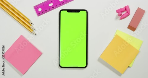 Using a green screen phone on a white work arts and crafts desk