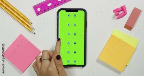 Using a green screen phone on a white work arts and crafts desk