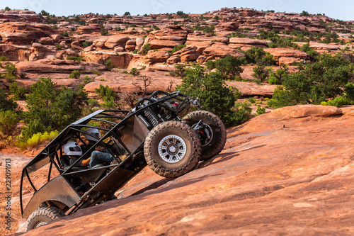 A Custom 4x4 Rock Crawler Off-Roading In The Sandstone Red Rock Terrain Outside Of Moab Utah In The American Southwest photo