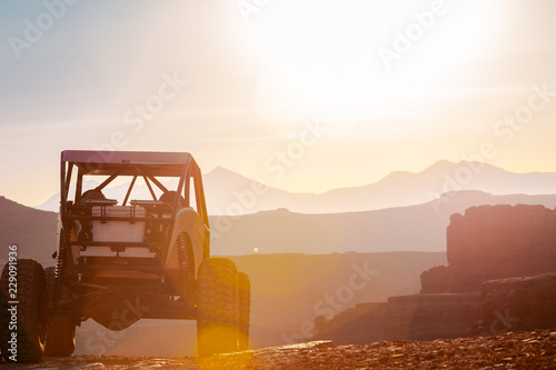 A Custom 4x4 Rock Crawler Off-Roading In The Sandstone Red Rock Terrain Outside Of Moab Utah In The American Southwest photo