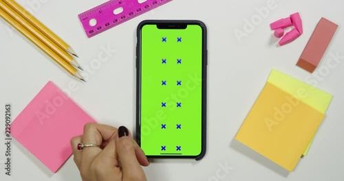 Using a green screen phone on a white work arts and crafts desk