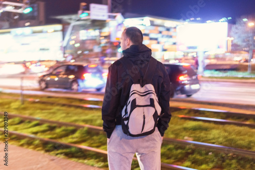 Man standing in front of motion blurred background.