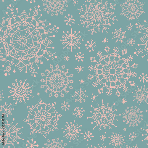 Winter christmas seamless pattern with pink snowflakes on blue background
