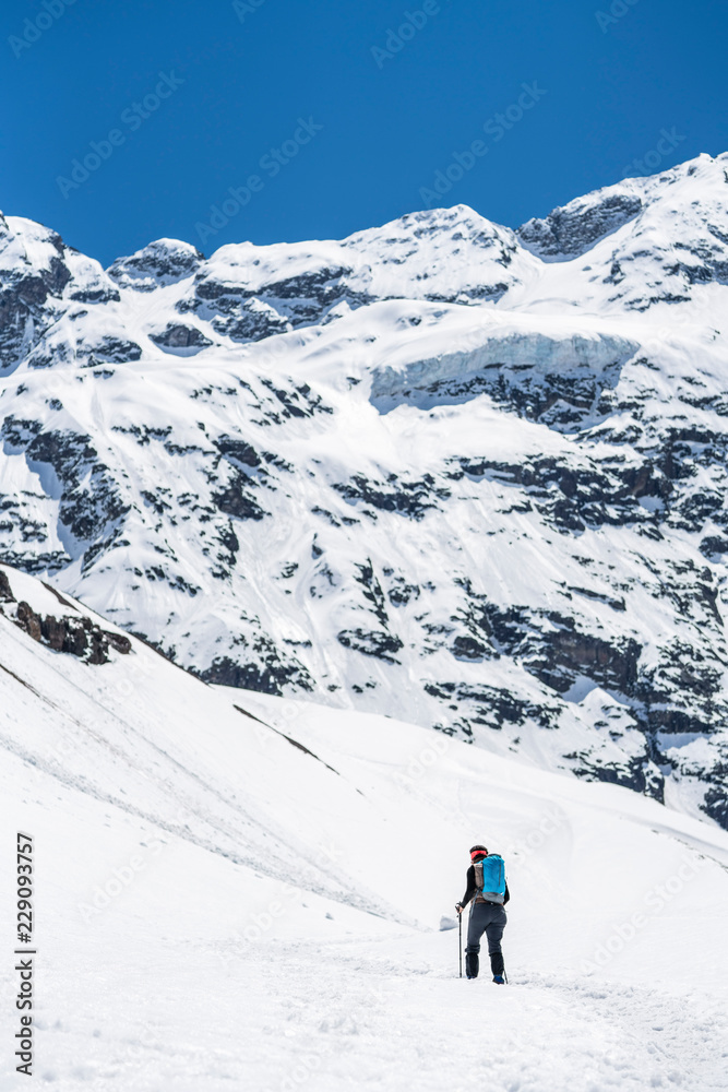 People doing trekking inside Andes valleys, crossing a snow valleys in central Chile at Cajon del Maipo, Santiago de Chile, amazing views over mountains and glaciers with awesome hiking exploration