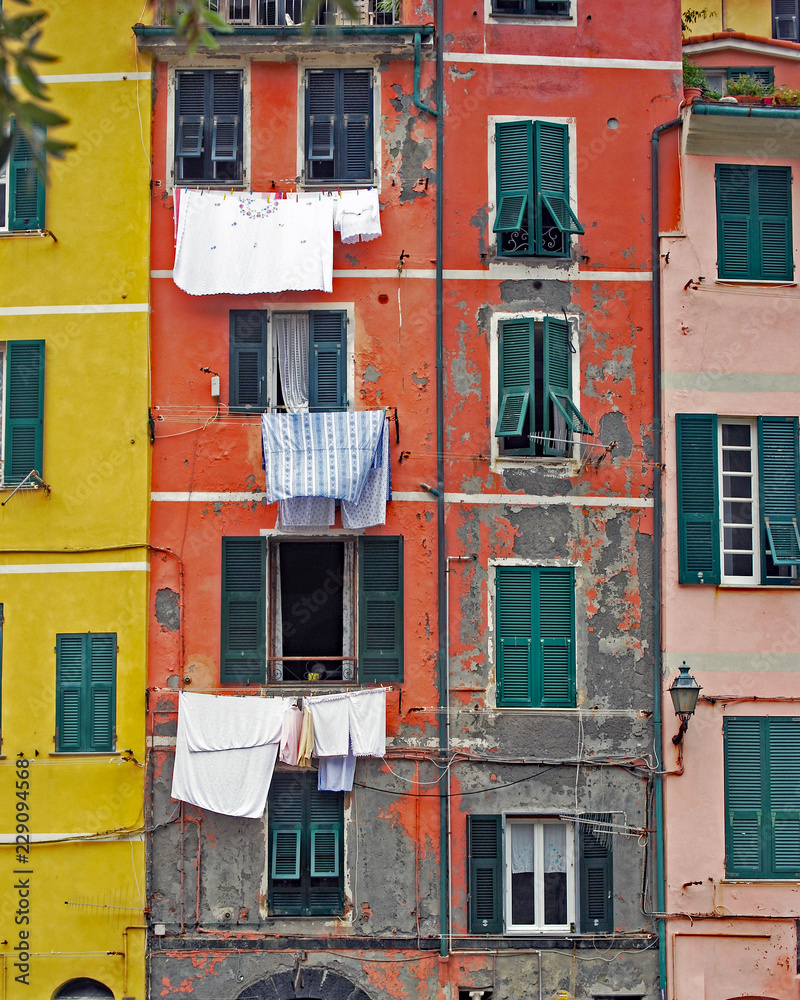 Laundry drying in front of colorful houses in Vernazza, Italy