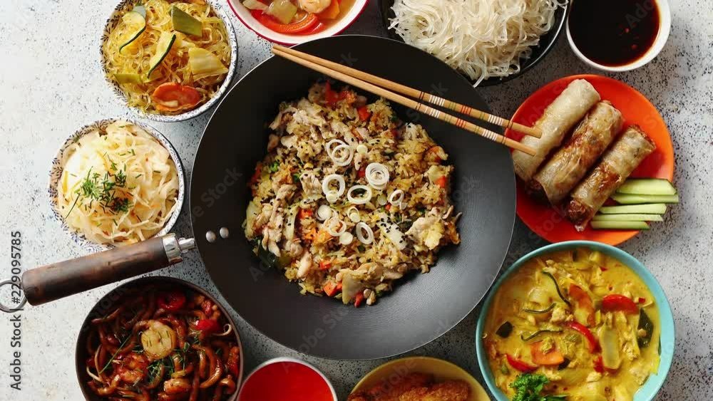 Asian oriental food composition in colorful dishware, served on stone, top view. Chinese, vietnamese, thai cuisine set. With copy space