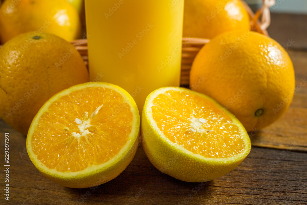 Some oranges in a basket on wooden background. Some oranges in a basket on wooden background.
