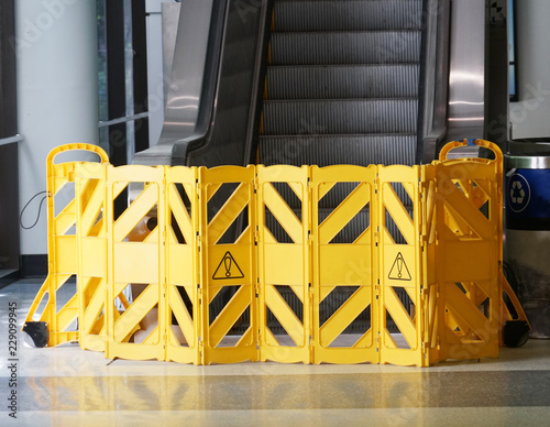 warning barrier blocking escalator indoors for maintenance