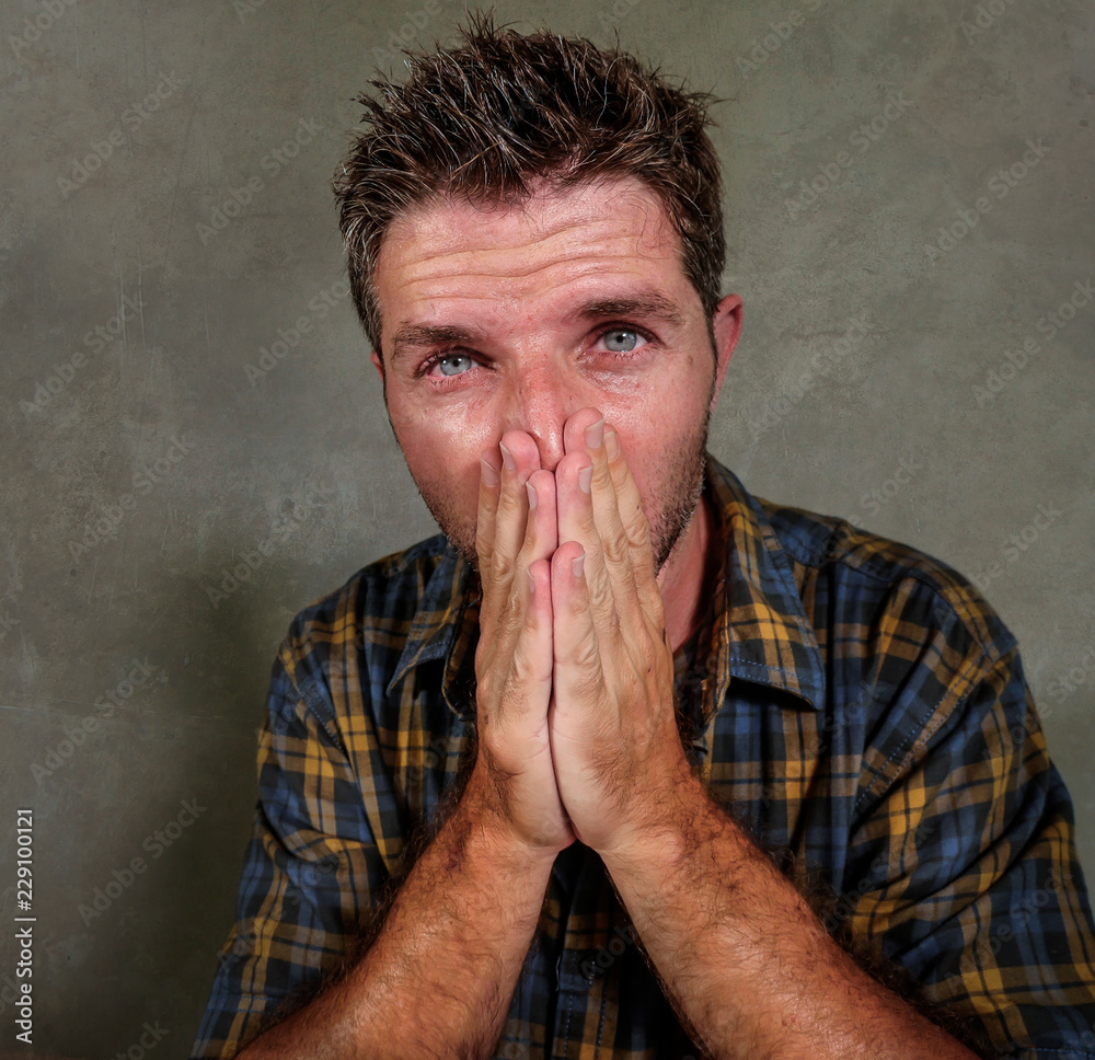 dramatic portrait of young sad and depressed man feeling anxious and overwhelmed crying desperate suffering depression problem and anxiety crisis on isolated background dramatic portrait of young sad and depressed man feeling anxious and overwhelmed crying desperate suffering depression problem and anxiety crisis on isolated background