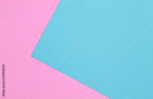 Blue and pink pastel color papers geometric flat laying.