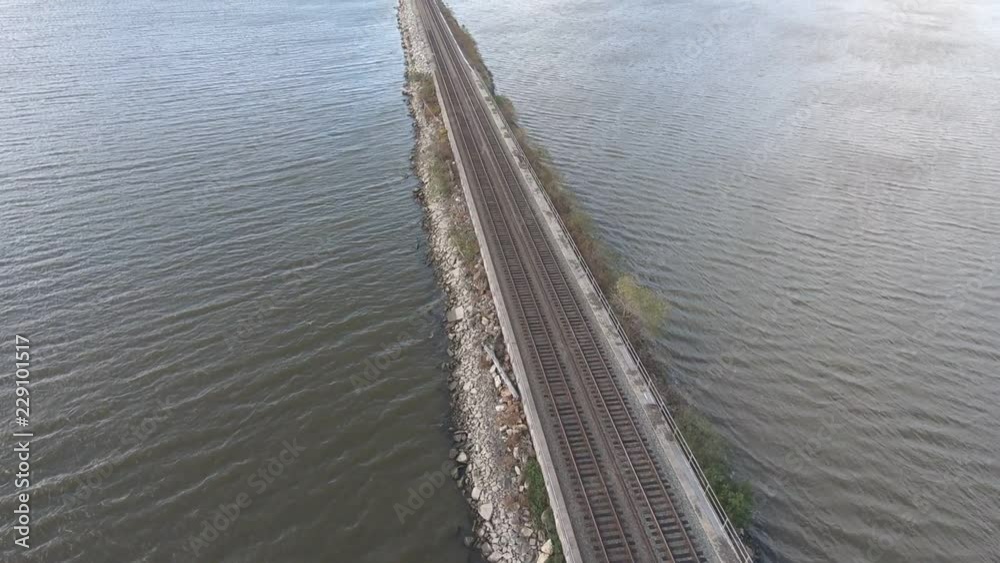 custom made wallpaper toronto digitalTrain passing under camera. Aerial view of train tracks cutting across water.