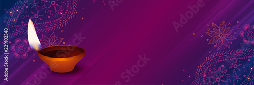 auspicious diwali diya on purple decorative background