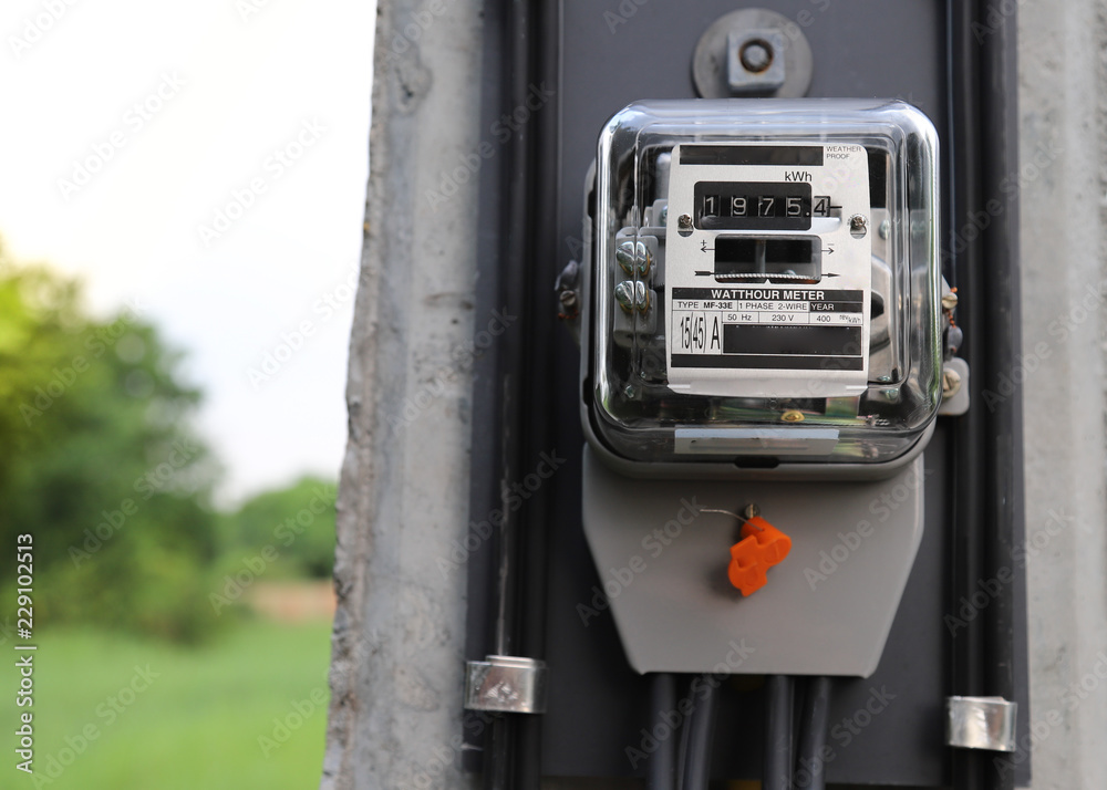 Closeup of electricity watt meter at the pole with natural background. Closeup of electricity watt meter at the pole with natural background.