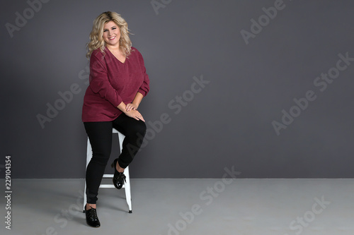 fat girl with a beautiful smile on a grey background