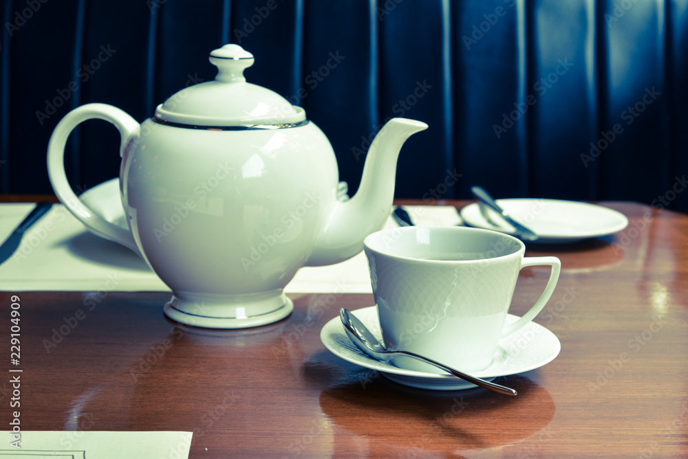 Dining table with tea and teapot Dining table with tea and teapot