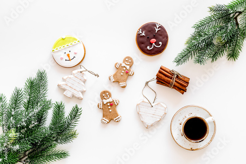 Gignerbread cookies for New Year 2019. Gingerbread man and cookies in shape of heart and new year spruce near cinnamon on white background top view copy space