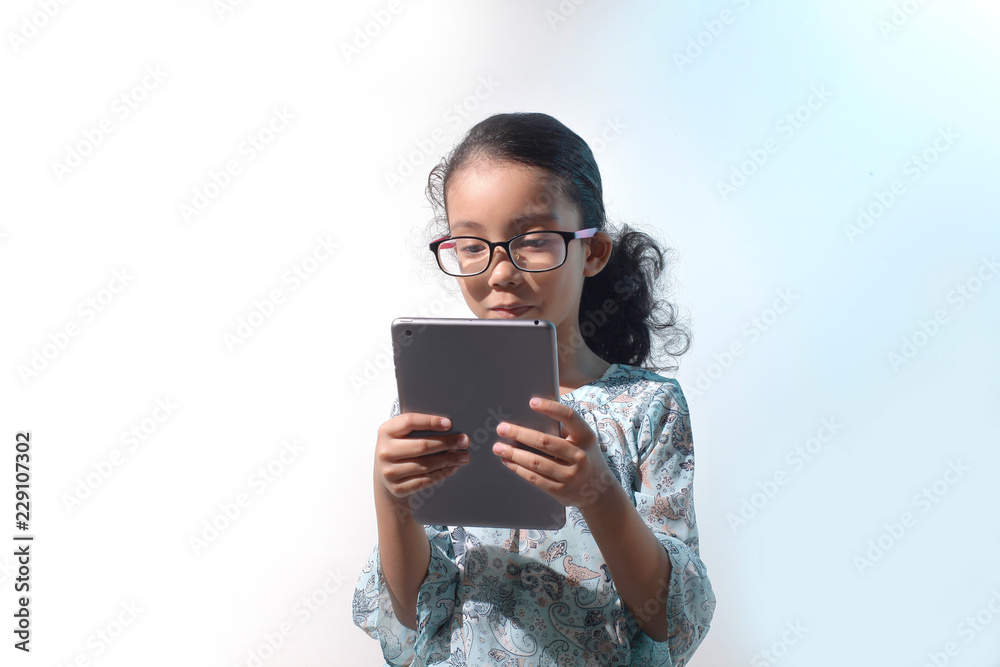 Fototapeta premium Glasses girl using digital tablet. Isolated on white background
