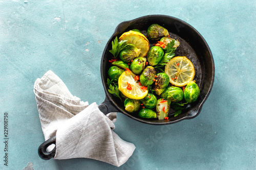 Frying pan fried Brussels sprouts background top view photo