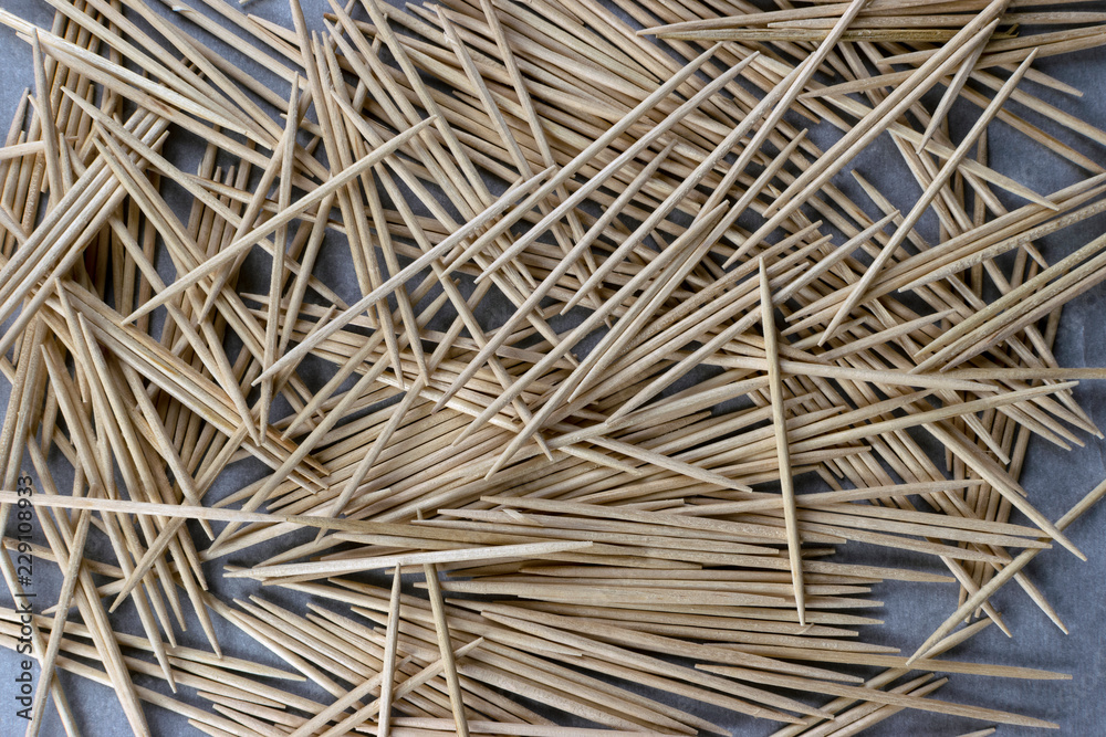 Closeup of wooden toothpicks scattered on table