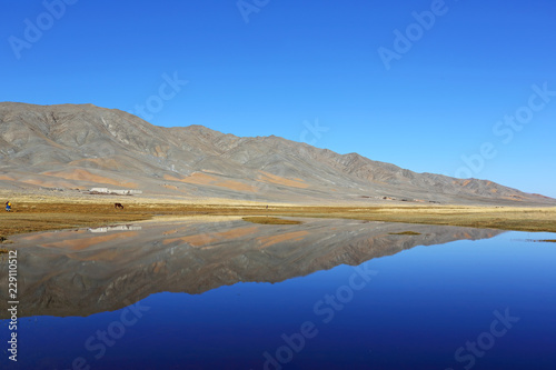 Reflection of lake after beautiful mountain with blue sky of Western Mongolia. Natural background 