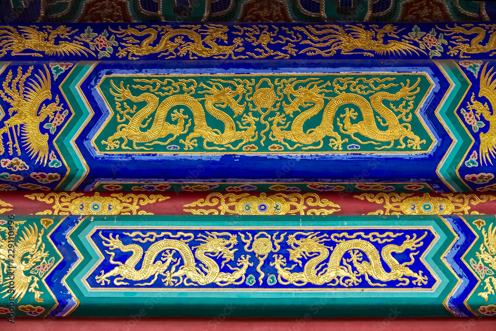 Ornate carved and painted beam with traditional Chinese designs in the Temple of Heaven in Beijing China Ornate carved and painted beam with traditional Chinese designs in the Temple of Heaven in Beijing China