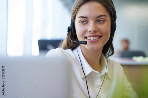 Tableau sur toile Customer support operator working in a call center office.