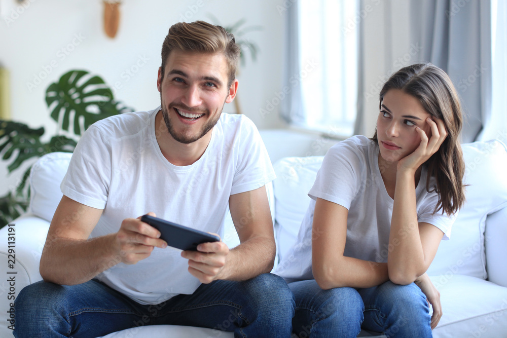 Annoyed Girlfriend Waiting for Boyfriend To Stop Playing Video-games Stock  Photo - Image of game, gamer: 100430632