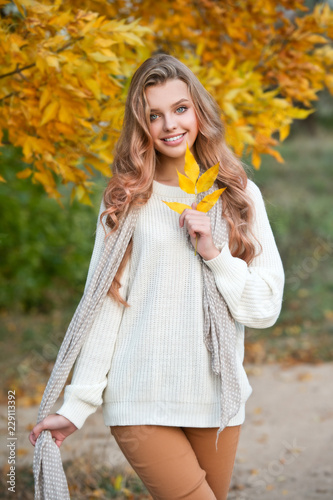 Beautiful girl walking outdoors in autumn.
