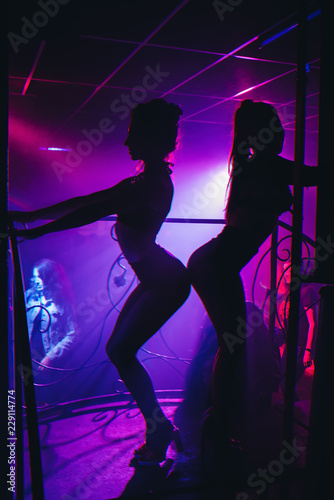 slender girl dancer in a nightclub posing on stage