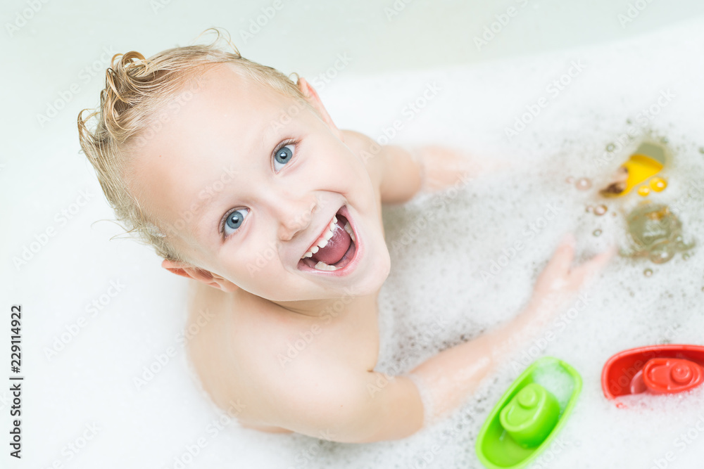 Happy baby bathes in the bathroom with foam Happy baby bathes in the bathroom with foam