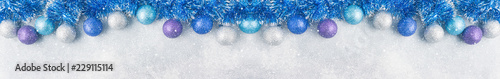 Blue Christmas balls and tinsel on grey background. New Year concept and scenery Banner photo