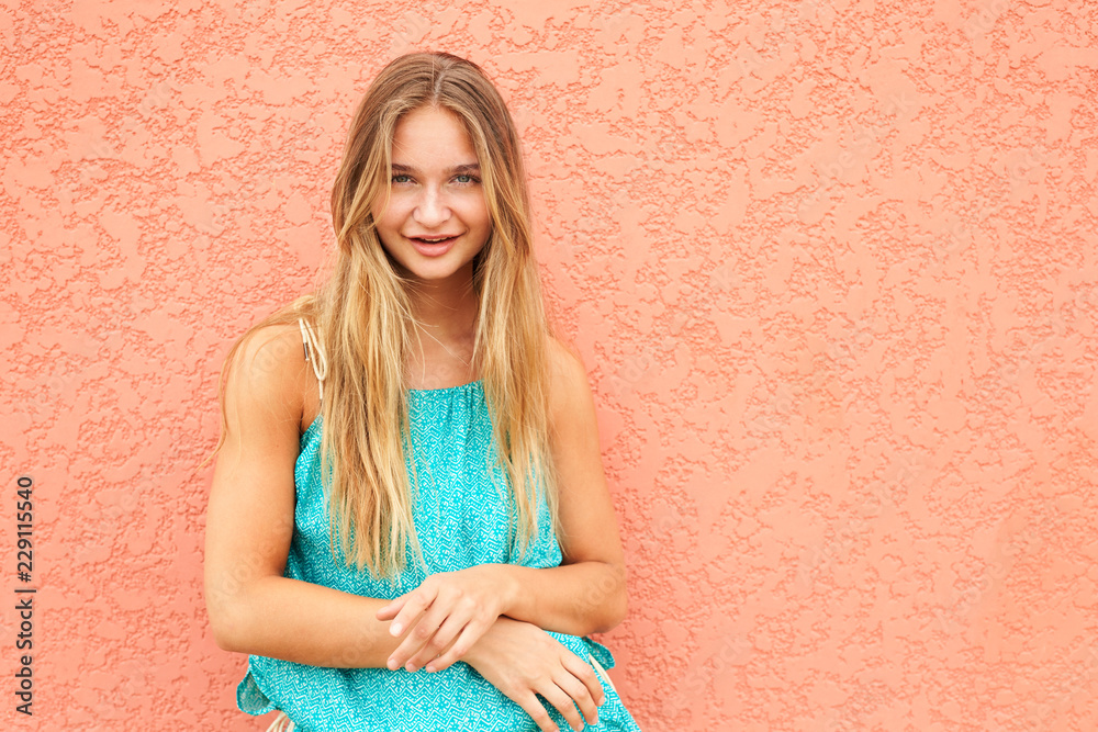 Pretty blond girl in turquoise, portrait