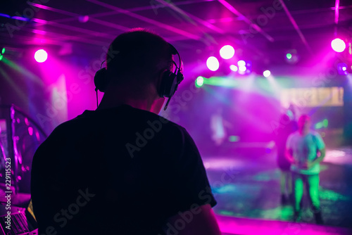 Wallpaper Mural DJ mixes music in a nightclub with people dancing on the dance floor Torontodigital.ca