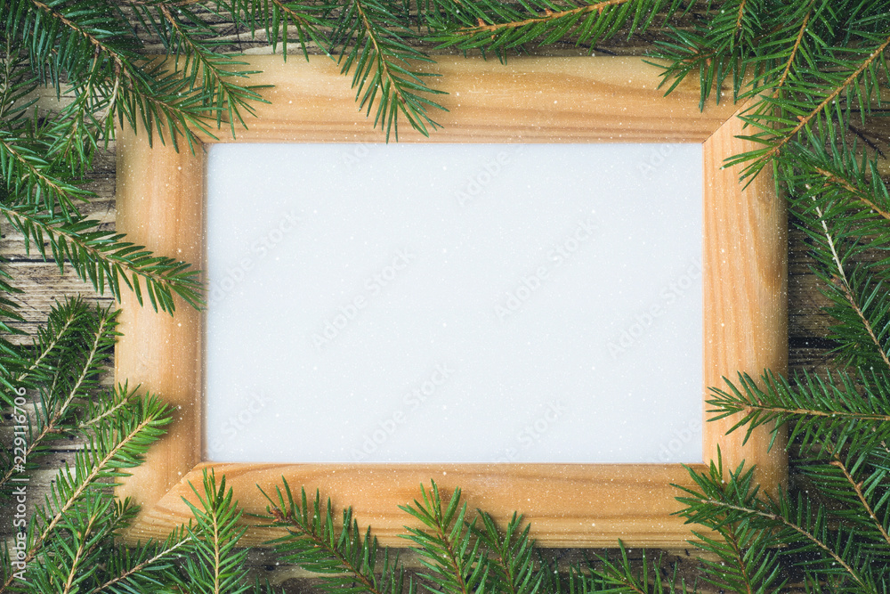 Creative layout made of Christmas tree branches with paper card note. Flat lay. Nature New Year concept. Creative layout made of Christmas tree branches with paper card note. Flat lay. Nature New Year concept.