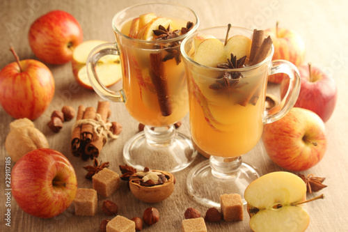 Two cups with hot cider in cold season with cinnamon and anise