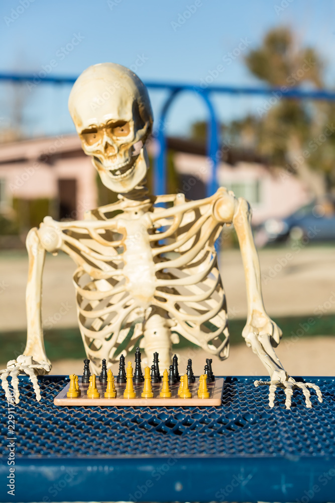 Skeleton scratches head trying to figure out next chess move Stock Photo -  Alamy