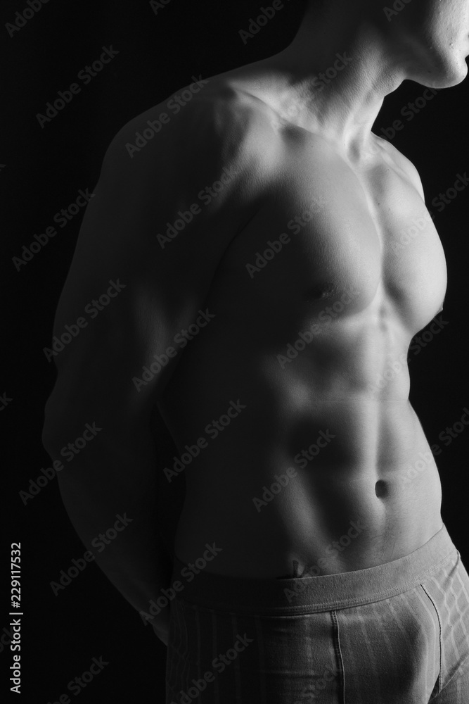 naked body of a man on black background naked body of a man on black background