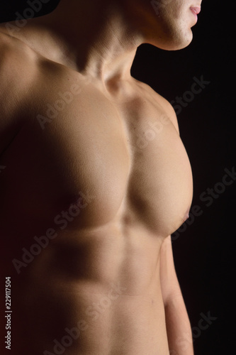 naked body of a man on black background