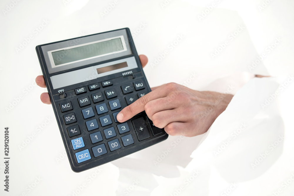 close up.businessman pressing the buttons of the calculator. close up.businessman pressing the buttons of the calculator.