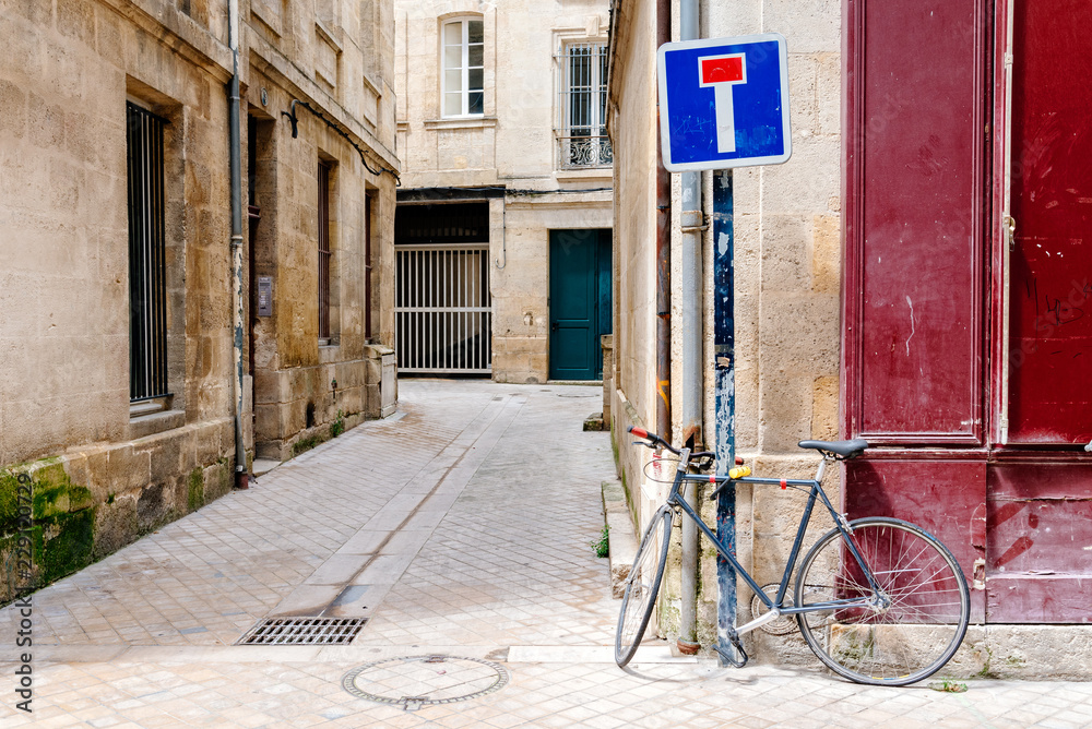 Bicycle parked in old narrow street of Bordeaux