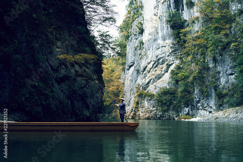 Man standing on raft in river