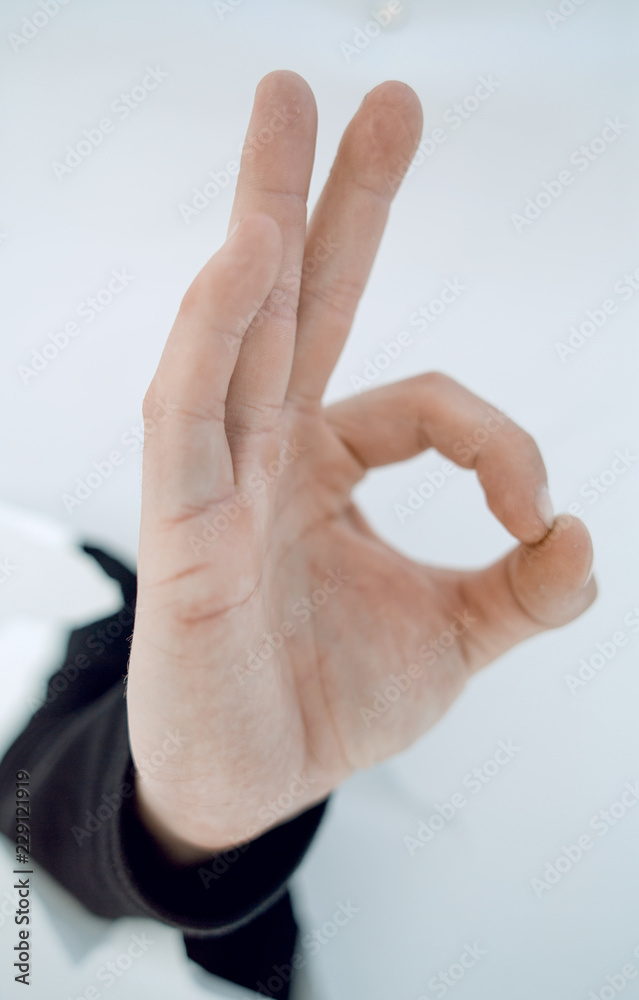 Naklejka premium image of hand businessman showing OK gesture