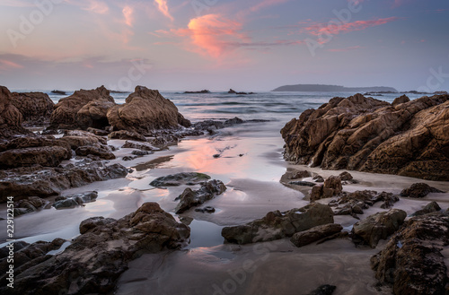 Coastal rocks and reflections in dawn hours