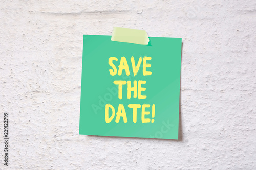 Save the date - memo pinned on white wall