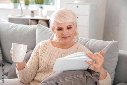 Beautiful mature woman drin...